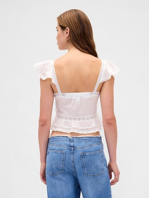 Top corto con peplum de gasa y volantes de encaje Top corto con peplum de gasa y volantes de encaje